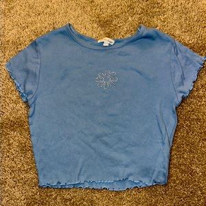 Derek Heart. Light blue crop top.